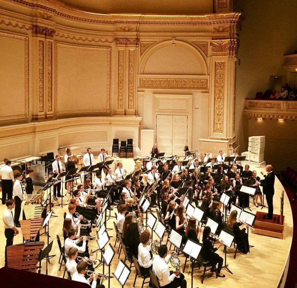 Concert Band on stage, pictured from stage right balcony. 